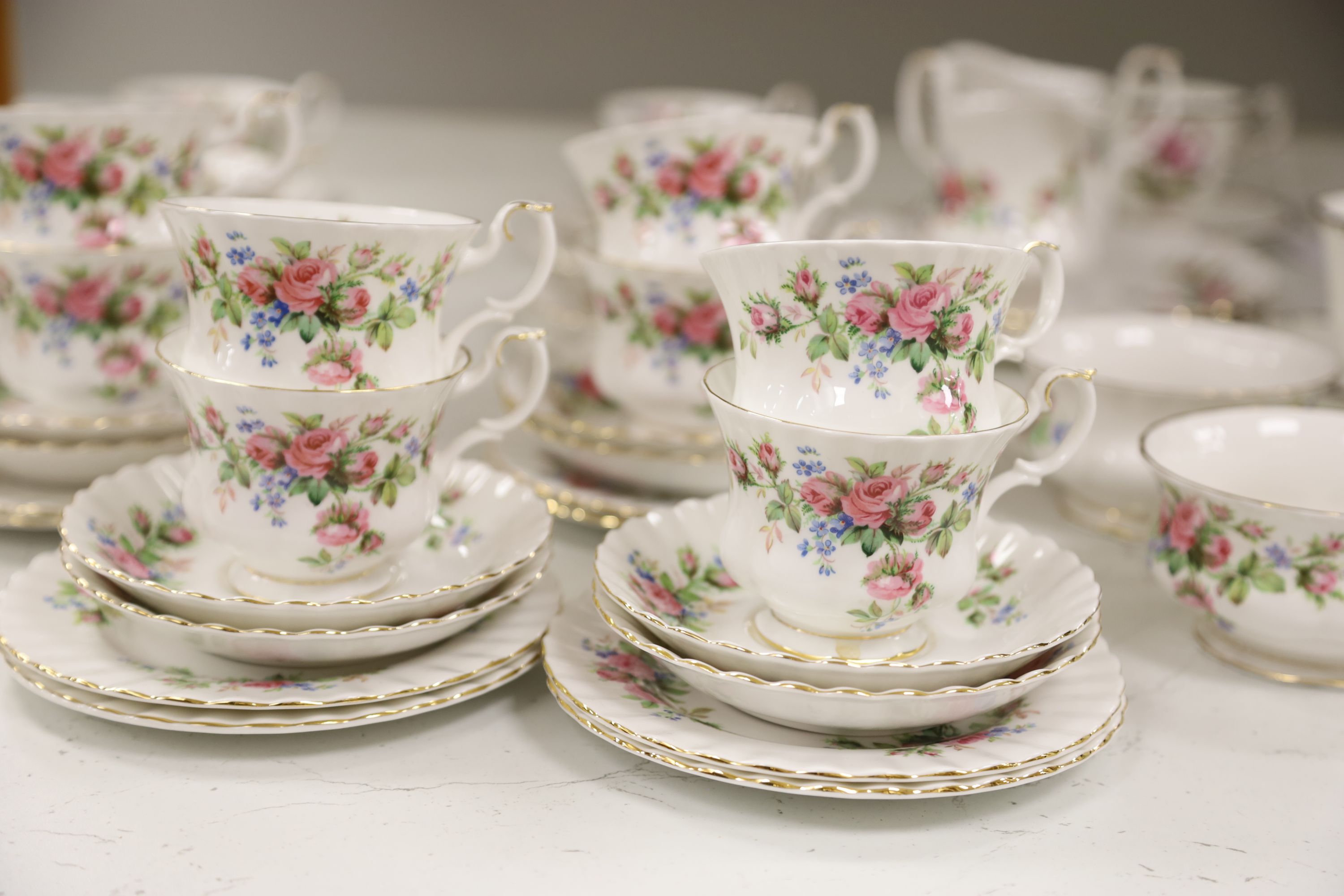 A Royal Albert Moss Rose pattern tea service (41-pce) and a set of four Coalport botanical cups and saucers